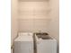 Convenient laundry room with washer, dryer, and shelving at 905 Fairview Club Cir, Dacula, GA 30019