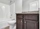 Bathroom with granite countertop, dark vanity, and shower/tub combo at 4251 Matisse Ln, Fairburn, GA 30213