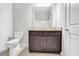 Bathroom with granite countertop, dark vanity, and toilet at 4251 Matisse Ln, Fairburn, GA 30213