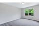 Bright bedroom with grey carpet and a large window at 4251 Matisse Ln, Fairburn, GA 30213