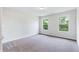 Spacious bedroom with grey carpet and two large windows at 4251 Matisse Ln, Fairburn, GA 30213