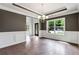 Elegant dining room with hardwood floors and wainscoting at 4251 Matisse Ln, Fairburn, GA 30213