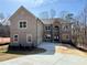 Stunning two-story brick home featuring a stone archway entrance and an attached garage on a spacious lot at 4251 Matisse Ln, Fairburn, GA 30213