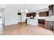 Kitchen with island, dark cabinets, and hardwood floors at 4251 Matisse Ln, Fairburn, GA 30213