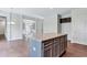 Kitchen island with granite countertop and dark brown cabinets at 4251 Matisse Ln, Fairburn, GA 30213