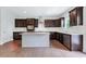 Kitchen with island, dark cabinets, and hardwood floors at 4251 Matisse Ln, Fairburn, GA 30213