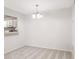 Bright dining room with view into kitchen and neutral carpeting at 1302 Woodcliff Dr, Atlanta, GA 30350