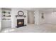 Living room with fireplace, built-in shelving and view into dining area at 1302 Woodcliff Dr, Atlanta, GA 30350