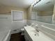 Clean bathroom with white tile, a vanity, and a bathtub at 2820 Arlington Rd, Atlanta, GA 30344