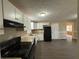 Efficient kitchen boasting white cabinets, black appliances, and a view into the dining area at 2820 Arlington Rd, Atlanta, GA 30344