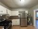 Updated kitchen features stainless steel appliances and light wood cabinets at 2053 Juanita St, Decatur, GA 30032
