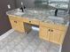 Bathroom vanity with double sinks, granite countertop, light wood cabinets, and modern fixtures at 1251 Marlton Chase Dr, Lawrenceville, GA 30044