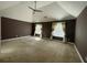 Large primary bedroom featuring neutral carpet, brown walls, and large windows at 1251 Marlton Chase Dr, Lawrenceville, GA 30044