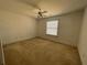 Bedroom with carpeted floors, ceiling fan, and a window providing natural light at 1251 Marlton Chase Dr, Lawrenceville, GA 30044