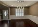 Bright dining room featuring a modern chandelier and plantation shutters for ample natural light at 1251 Marlton Chase Dr, Lawrenceville, GA 30044