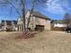 Spacious brick home with an attached garage and mature tree in the front yard at 1251 Marlton Chase Dr, Lawrenceville, GA 30044