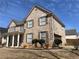 Brick home showcasing a front porch, attached garage, and well-kept landscaping at 1251 Marlton Chase Dr, Lawrenceville, GA 30044