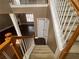 View of the living room from the staircase landing, showcasing the open floor plan at 1251 Marlton Chase Dr, Lawrenceville, GA 30044