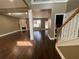 Hardwood floors and trim with a fireplace visible from the staircase in the living room at 1251 Marlton Chase Dr, Lawrenceville, GA 30044