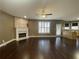 Open-concept living area with hardwood floors, fireplace and view of the kitchen island at 1251 Marlton Chase Dr, Lawrenceville, GA 30044