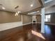 Open concept living room featuring hardwood floors, fireplace, and natural light from the windows at 1251 Marlton Chase Dr, Lawrenceville, GA 30044