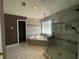 Main bathroom with shower, soaking tub, and tile accents at 1251 Marlton Chase Dr, Lawrenceville, GA 30044