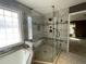 Well-lit glass shower and soaking tub with window at 1251 Marlton Chase Dr, Lawrenceville, GA 30044