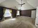 Sun-filled main bedroom with large windows, curtains, and neutral carpet at 1251 Marlton Chase Dr, Lawrenceville, GA 30044