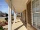 A brick home with a covered porch, white columns, and manicured landscaping at 1251 Marlton Chase Dr, Lawrenceville, GA 30044