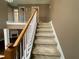 Carpeted staircase with white railing leading to the upper level of the home at 1251 Marlton Chase Dr, Lawrenceville, GA 30044