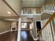 View of the staircase and hardwood floors and trim; note the fireplace in the back of the home at 1251 Marlton Chase Dr, Lawrenceville, GA 30044