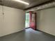 Unfinished basement featuring a door leading to the exterior, concrete floor, and a window at 2071 Carthage Rd, Tucker, GA 30084