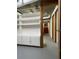 Unfinished basement featuring built-in shelving and stairs at 2071 Carthage Rd, Tucker, GA 30084