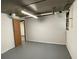 Unfinished basement featuring painted concrete floor, white walls, and a window for natural light at 2071 Carthage Rd, Tucker, GA 30084