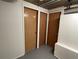 Basement showing three wooden doors and unfinished white walls at 2071 Carthage Rd, Tucker, GA 30084