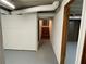 Hallway in unfinished basement, featuring stairs and doorway at 2071 Carthage Rd, Tucker, GA 30084