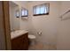 Half bath with vanity and mirror, window and tile flooring at 2071 Carthage Rd, Tucker, GA 30084