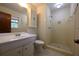 Bathroom featuring a single sink vanity, toilet, linen closet, and walk-in shower with tiled walls at 2071 Carthage Rd, Tucker, GA 30084