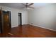 Bedroom with hardwood floors, neutral walls, ceiling fan, and closet with doors at 2071 Carthage Rd, Tucker, GA 30084