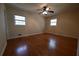 Bedroom with hardwood floors, neutral walls, ceiling fan, and windows that provide natural light at 2071 Carthage Rd, Tucker, GA 30084