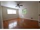 Bedroom featuring hardwood floors, neutral walls, a ceiling fan, and a window that provides natural light at 2071 Carthage Rd, Tucker, GA 30084