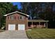 Traditional brick home with a two-car garage, complemented by red shutters and a well-maintained lawn at 2071 Carthage Rd, Tucker, GA 30084