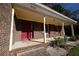 Welcoming front porch with brick steps, red door, and red shutters at 2071 Carthage Rd, Tucker, GA 30084