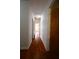 Hallway featuring hardwood floors and neutral walls that leads to various rooms in the home at 2071 Carthage Rd, Tucker, GA 30084