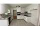 Updated kitchen featuring white cabinets, granite countertops, tile backsplash, stainless appliances and tile floor at 2071 Carthage Rd, Tucker, GA 30084