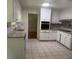 Traditional kitchen with granite countertops, white cabinets, and tiled flooring at 2071 Carthage Rd, Tucker, GA 30084