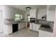 Updated kitchen featuring white cabinets, granite countertops, tile backsplash, stainless appliances and tile floor at 2071 Carthage Rd, Tucker, GA 30084