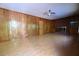 Spacious living room features wood paneling, brick fireplace, ceiling fan and wood laminate flooring at 2071 Carthage Rd, Tucker, GA 30084