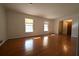 Spacious living room showcasing hardwood floors, neutral walls, and large windows at 2071 Carthage Rd, Tucker, GA 30084
