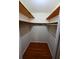 Walk-in closet with wood floors and wood shelving at 2071 Carthage Rd, Tucker, GA 30084